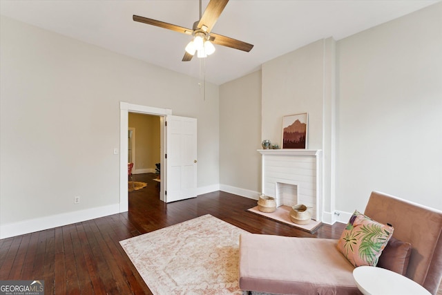 sitting room featuring dark hardwood / wood-style floors and ceiling fan