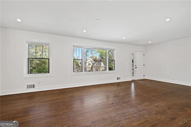 empty room with dark wood-type flooring