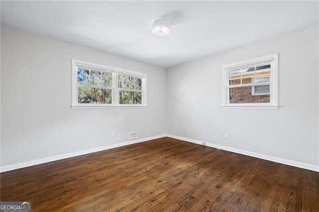 unfurnished room featuring dark hardwood / wood-style flooring