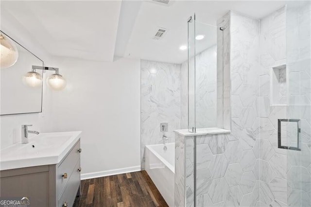 bathroom with vanity, hardwood / wood-style flooring, and shower with separate bathtub