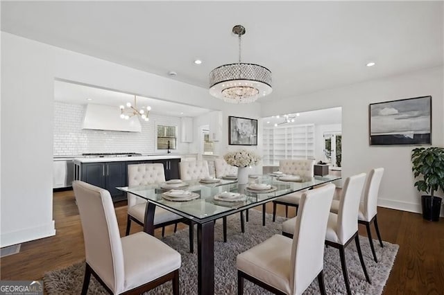 dining area featuring dark hardwood / wood-style flooring and a chandelier