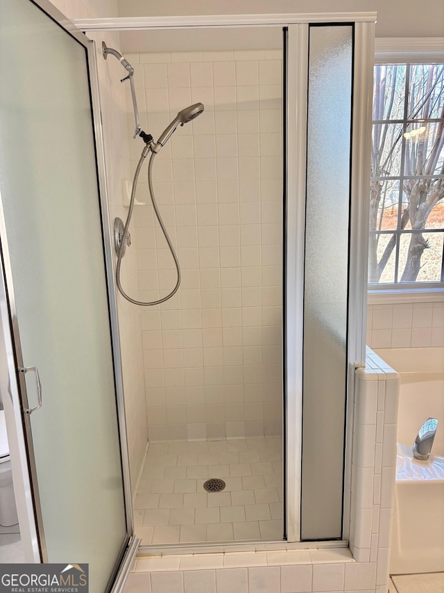 bathroom featuring an enclosed shower, a wealth of natural light, and toilet