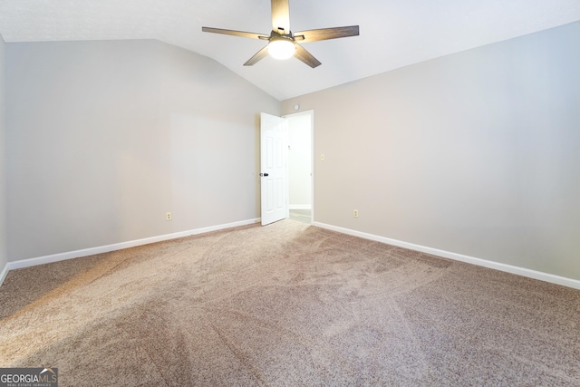 carpeted empty room featuring lofted ceiling and ceiling fan