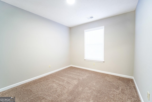 spare room featuring carpet