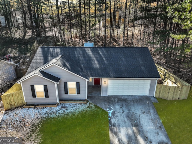 single story home featuring a garage and a front lawn