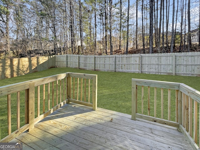 wooden deck featuring a yard