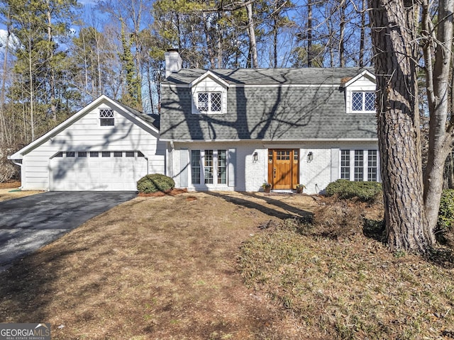 cape cod home with a garage