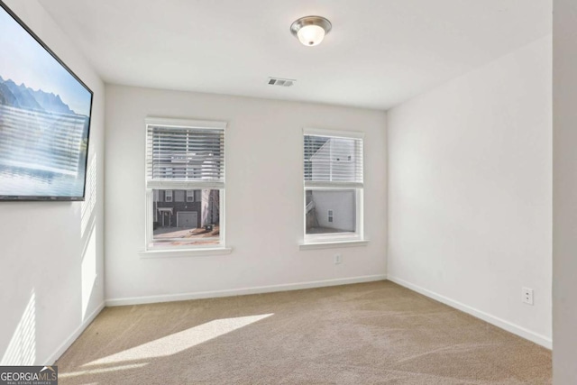 unfurnished room with plenty of natural light and light colored carpet