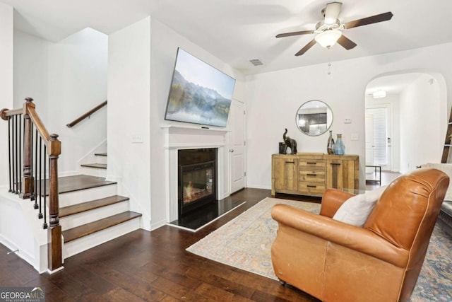 living room featuring dark hardwood / wood-style floors and ceiling fan