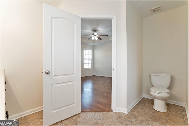 bathroom featuring ceiling fan and toilet