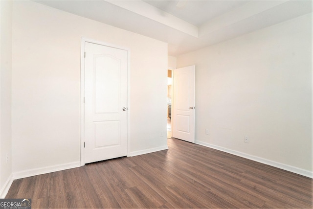 unfurnished bedroom featuring dark hardwood / wood-style flooring