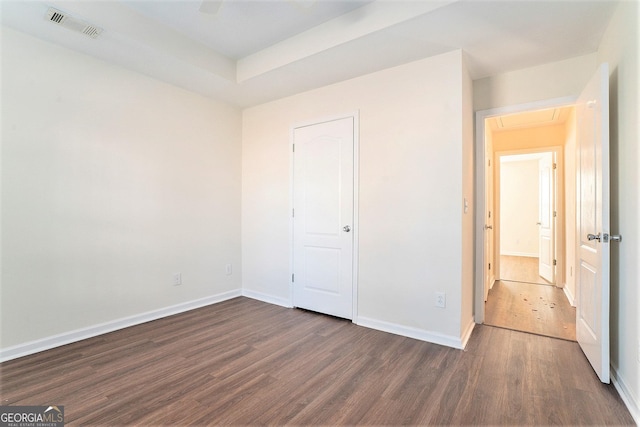 unfurnished bedroom with dark hardwood / wood-style flooring