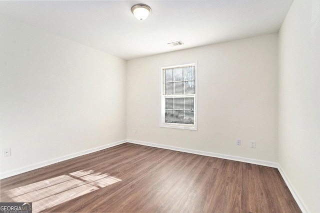 spare room featuring hardwood / wood-style floors