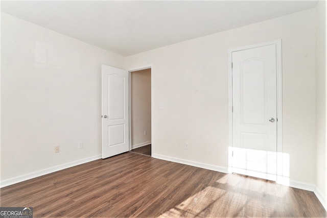 unfurnished room featuring dark hardwood / wood-style flooring