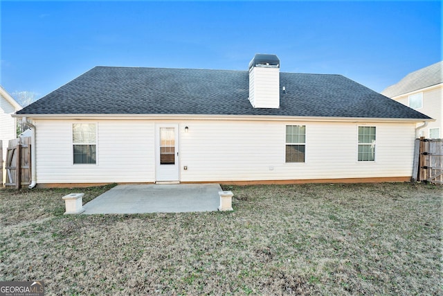 rear view of property featuring a yard and a patio