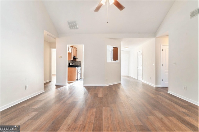 unfurnished living room featuring dark wood-type flooring, high vaulted ceiling, and ceiling fan