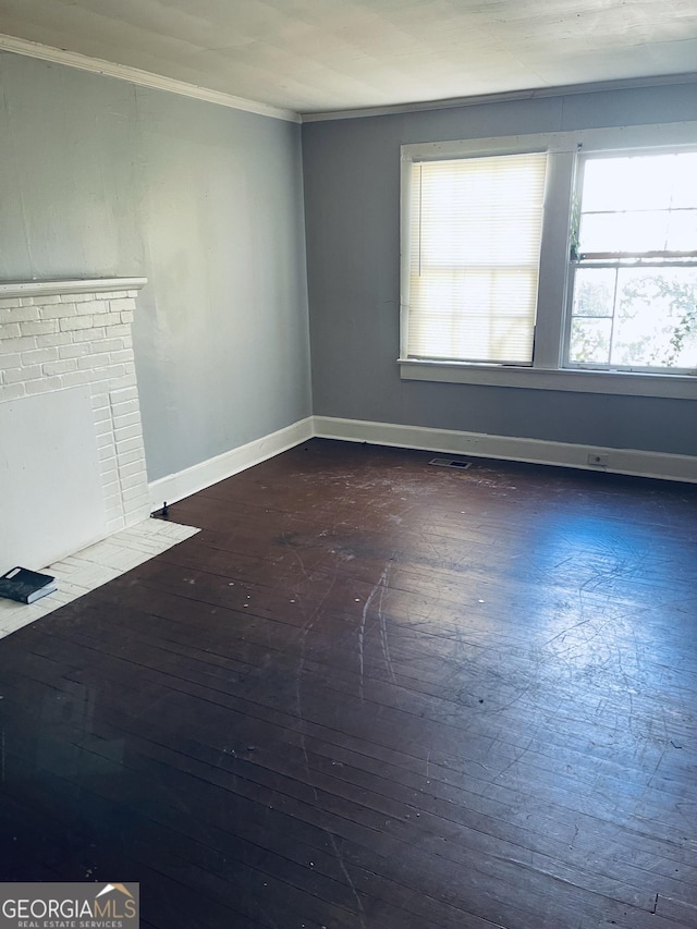 unfurnished room featuring ornamental molding and dark hardwood / wood-style flooring