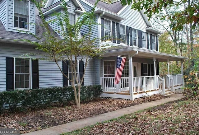 view of front of home with a porch and a shingled roof