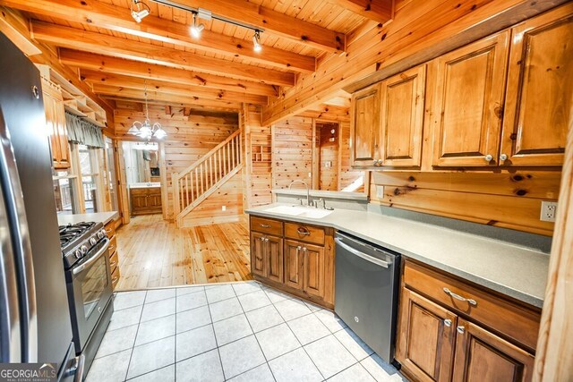 empty room featuring beamed ceiling, ceiling fan, wood ceiling, and light hardwood / wood-style floors