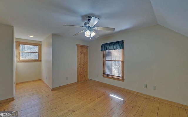 empty room with ceiling fan and light hardwood / wood-style floors