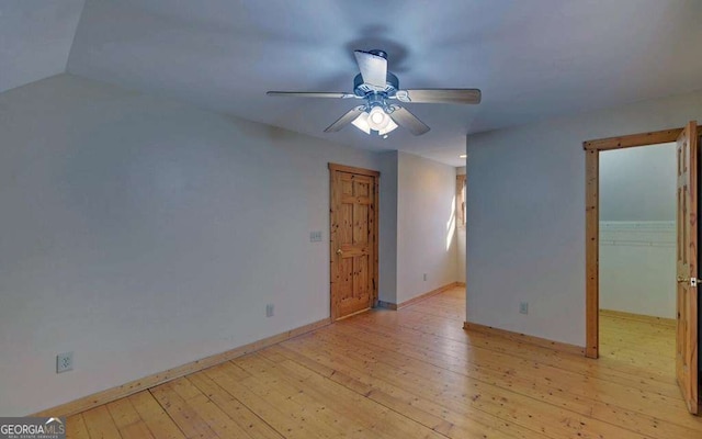 interior space with a spacious closet, light hardwood / wood-style floors, a closet, and ceiling fan