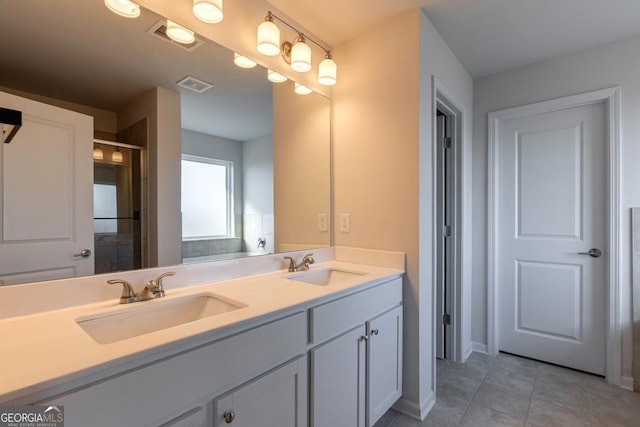 bathroom featuring tile patterned flooring and vanity