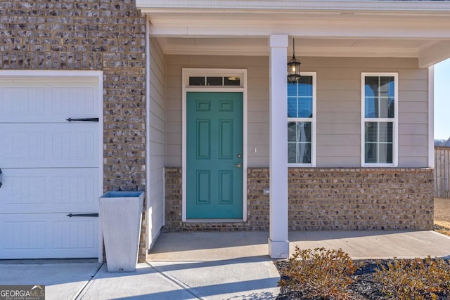 entrance to property with a garage and covered porch