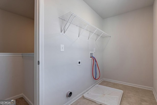 laundry room with electric dryer hookup, hookup for a washing machine, and light tile patterned floors