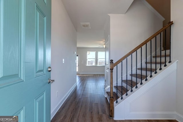 foyer entrance with dark hardwood / wood-style floors and ceiling fan