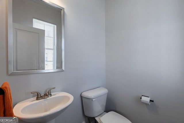 bathroom featuring toilet and sink