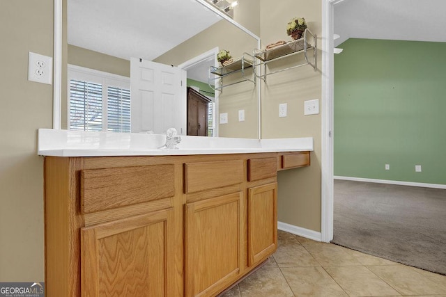 bathroom with tile patterned floors and vanity