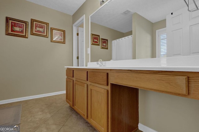 bathroom featuring tile patterned flooring and vanity