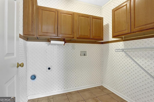 laundry area featuring light tile patterned flooring, cabinets, hookup for an electric dryer, and hookup for a washing machine