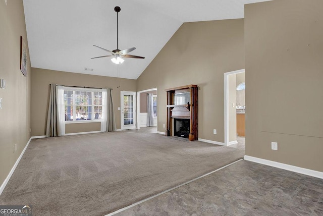 unfurnished living room featuring ceiling fan, carpet flooring, and high vaulted ceiling