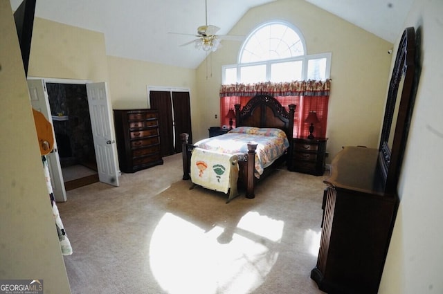 bedroom with ceiling fan, high vaulted ceiling, and light carpet