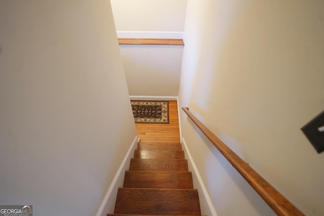 stairway featuring wood-type flooring