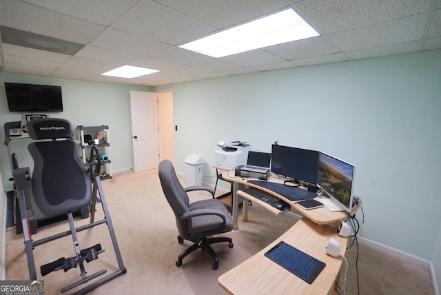 carpeted home office featuring a paneled ceiling