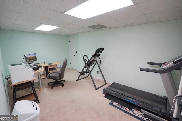 carpeted office with a paneled ceiling