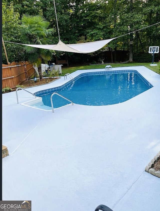 view of pool featuring a diving board