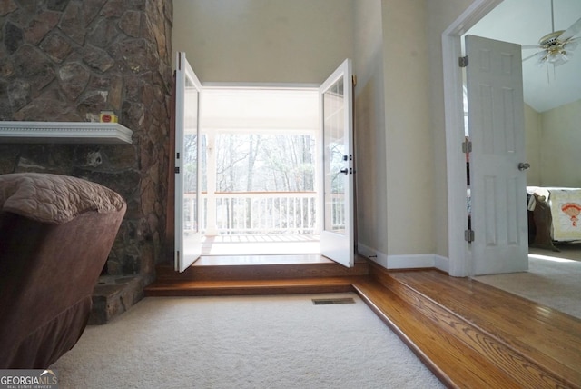 interior space with ceiling fan and carpet flooring