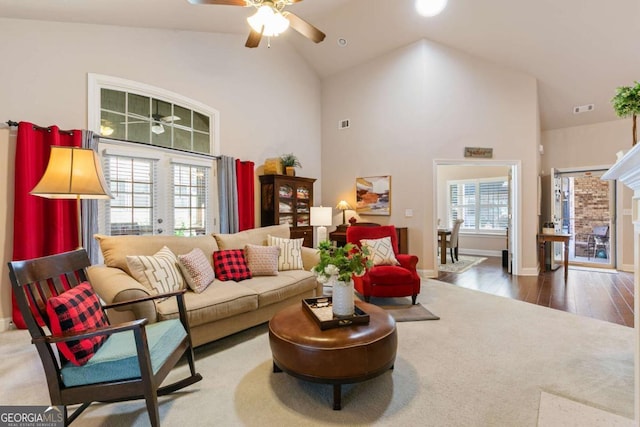 living room with wood-type flooring, high vaulted ceiling, and ceiling fan