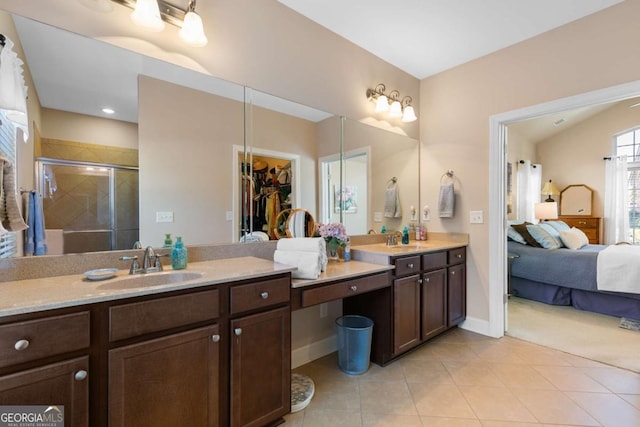 bathroom featuring vanity, a shower with shower door, and tile patterned flooring