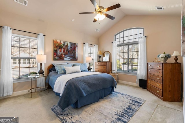 bedroom featuring vaulted ceiling, light carpet, and ceiling fan