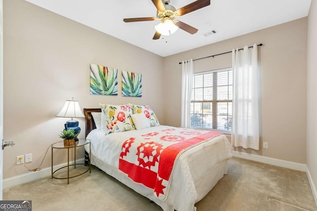 bedroom with ceiling fan and light carpet