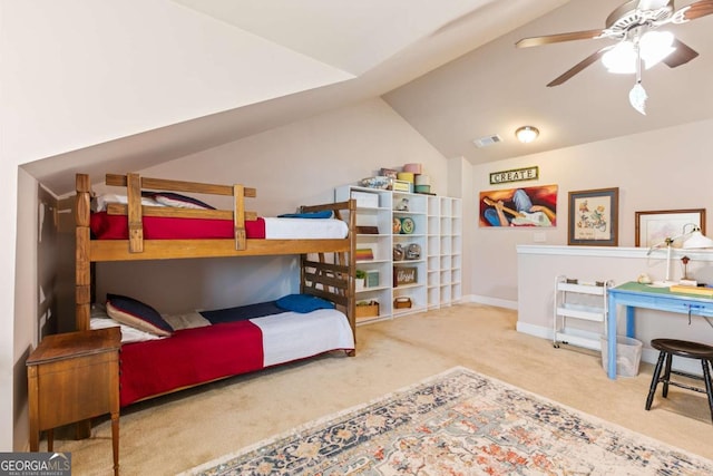 carpeted bedroom with vaulted ceiling and ceiling fan