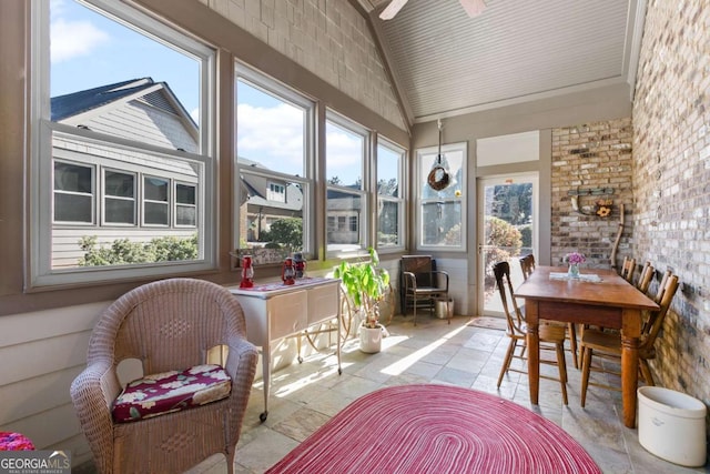 sunroom with plenty of natural light and vaulted ceiling