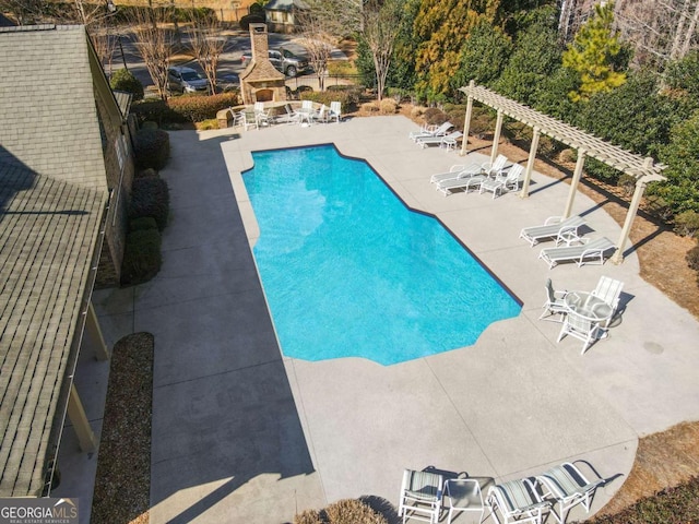 view of pool with a pergola, a fireplace, and a patio