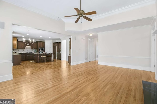 unfurnished living room with crown molding, ceiling fan with notable chandelier, and light hardwood / wood-style flooring