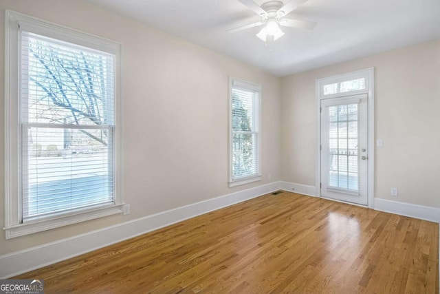 spare room with hardwood / wood-style floors and ceiling fan