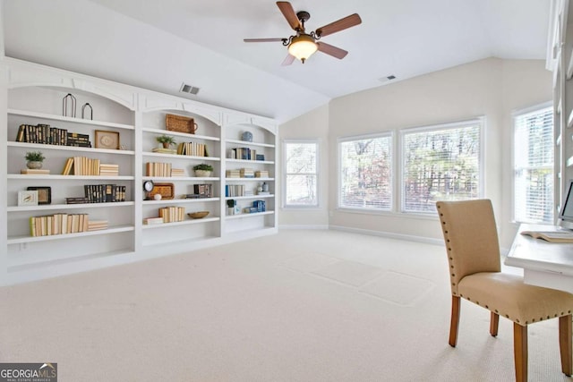 living area featuring ceiling fan, a healthy amount of sunlight, lofted ceiling, and carpet flooring